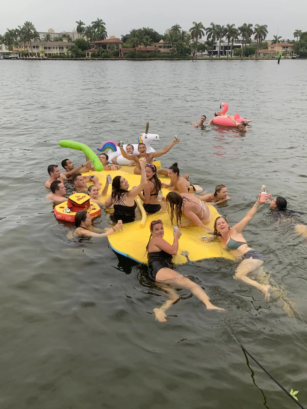 Friends celebrating a birthday on the water at sunset aboard Breezy Tiki