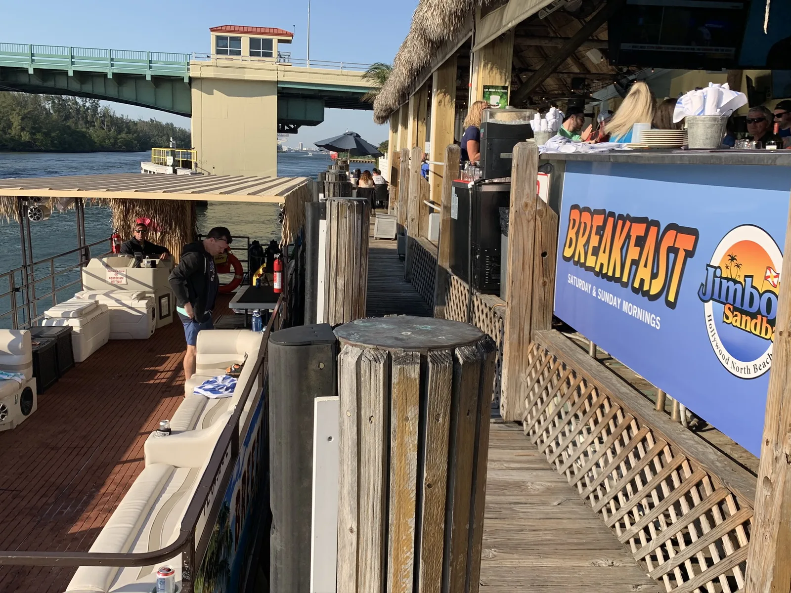 The Breezy Tiki pontoon boat docked on the Fort Lauderdale intracoastal at golden hour